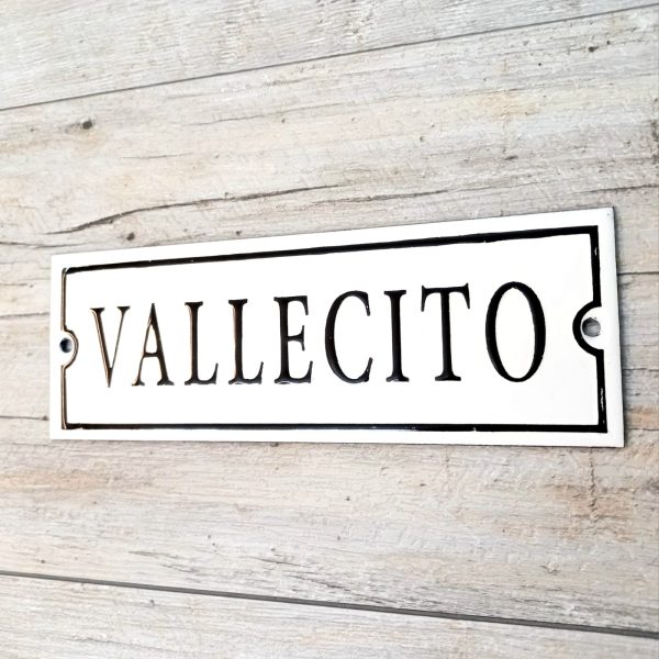 Cartel enlozado 20x7 cm fondo blanco texto "VALLECITO" en negro